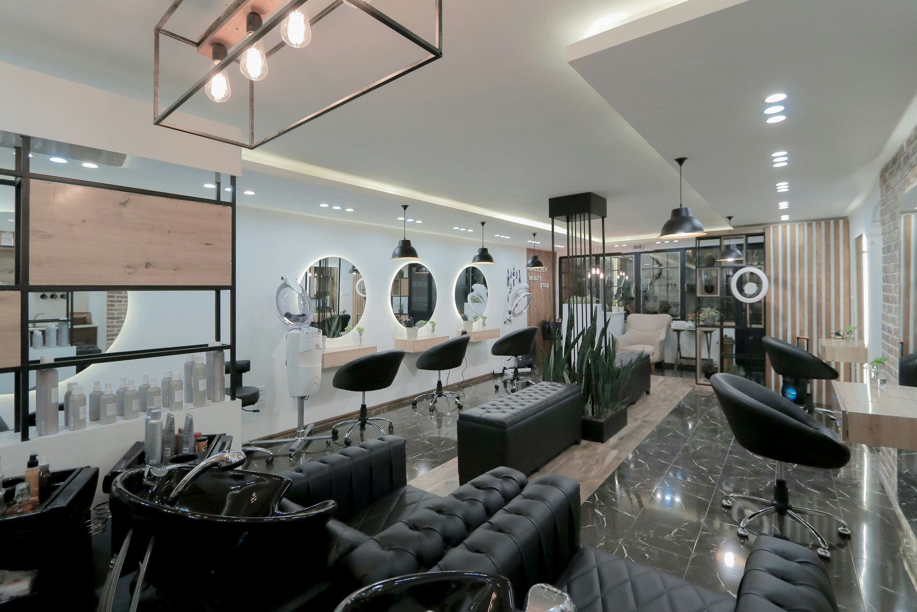 Inside the Maison Laurel studio: styling chairs, round backlit mirrors and greenery